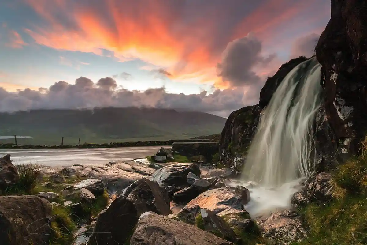 Waterfall-on-the-Conor-Pass-Dingle-Kerry-Ireland. The waterfall beside the lay-by on the Conor Pass Road, Dingle, Kerry, Ireland captured at sunset.